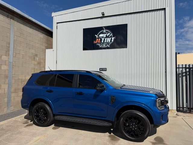 Blue Ford Everest with premium window tint, parked outside the JL Tint shop