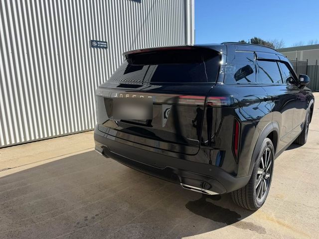 Black Jaecoo SUV, rear view, with premium window tint, parked outside the JL Tint shop