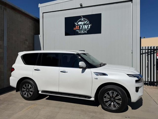 White Nissan Patrol V8 with premium window tint, parked outside the JL Tint shop
