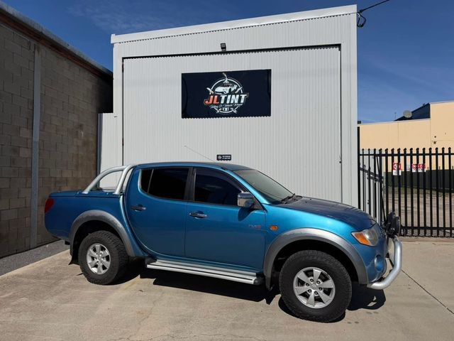 Mitsubishi Triton with premium window tint, parked outside the JL Tint shop